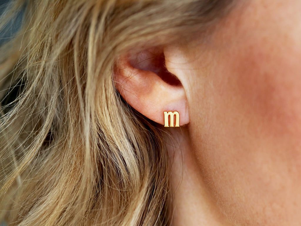 Lowercase initial earrings by Tom Design Shop.