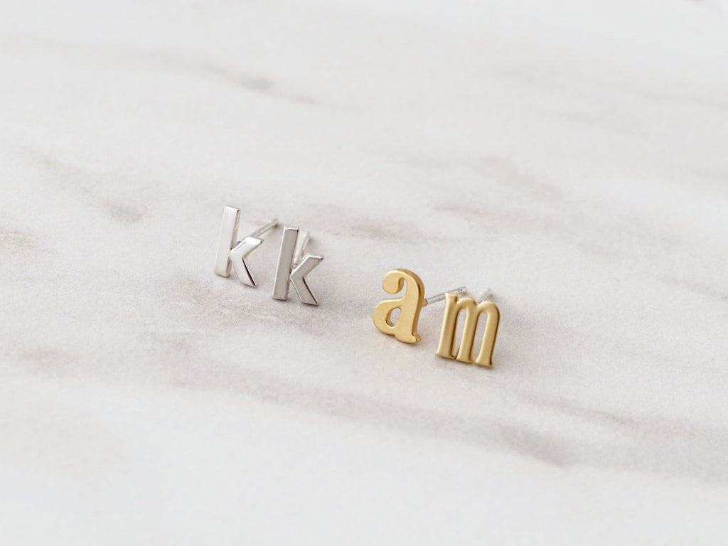 Lowercase initial earrings available in gold and silver from Tom Design Shop.