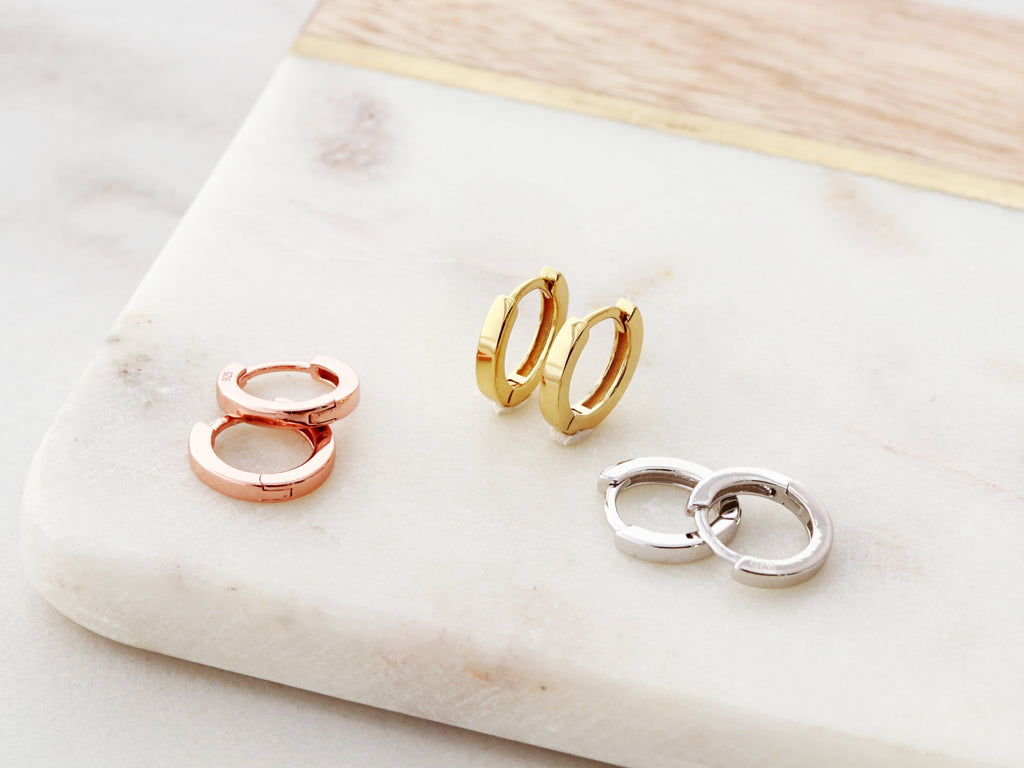 Solid huggie earrings in gold, silver, and rose gold from Tom Design Shop.