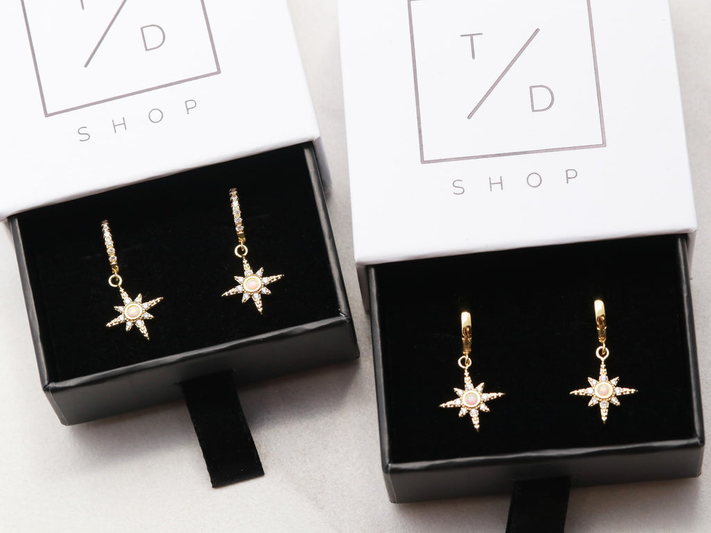 Tom Design Shop offers gold starbust huggie earrings.