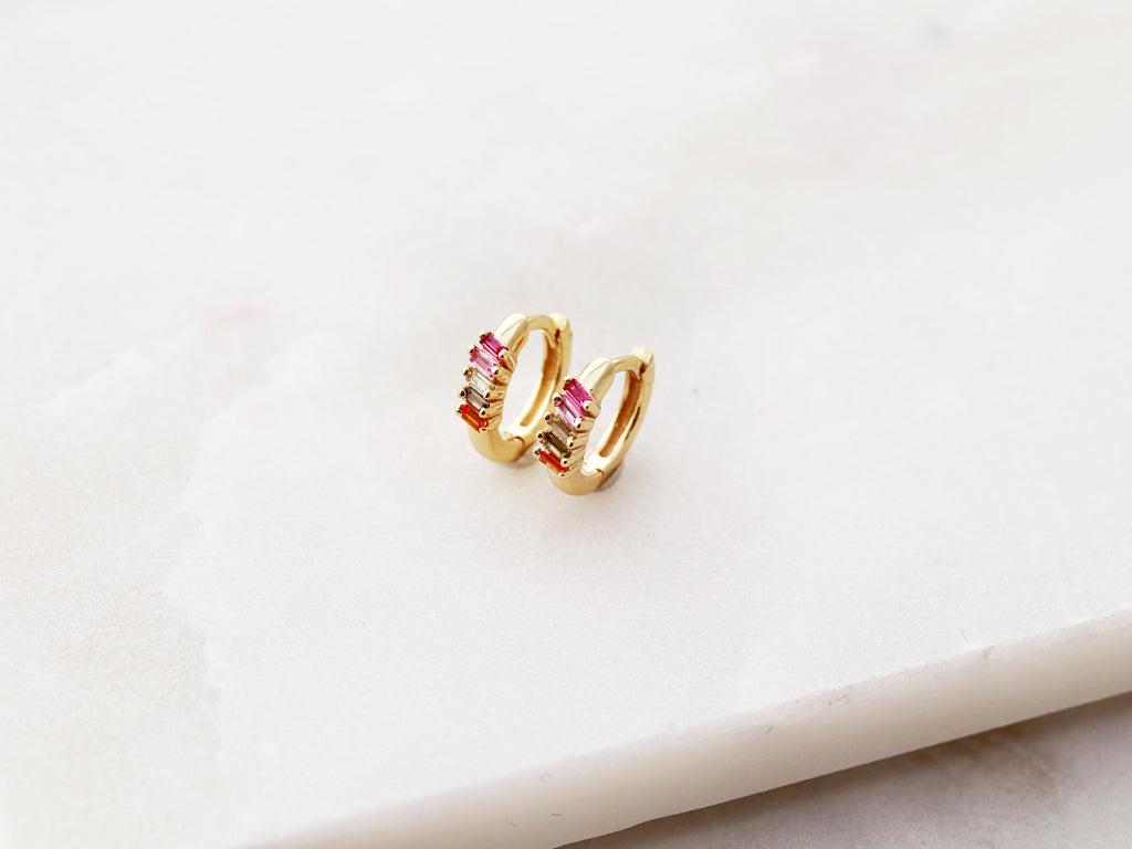 Gold, tiny rainbow huggie earrings from Tom Design Shop.