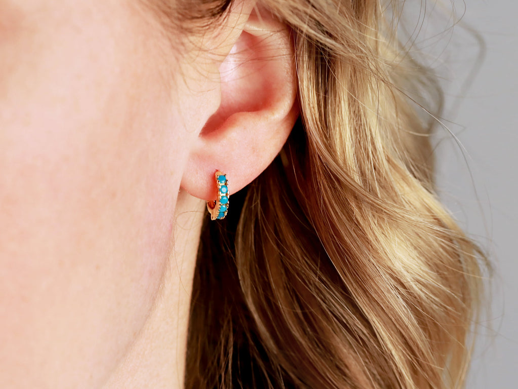 Turquoise Huggie Earrings in gold from Tom Design Jewelry.